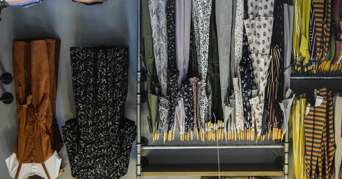 Realistic apparel retail rack in a boutique environment with warm overhead lighting, uniquely composed for Target, Pinnacle, and Ramaco...