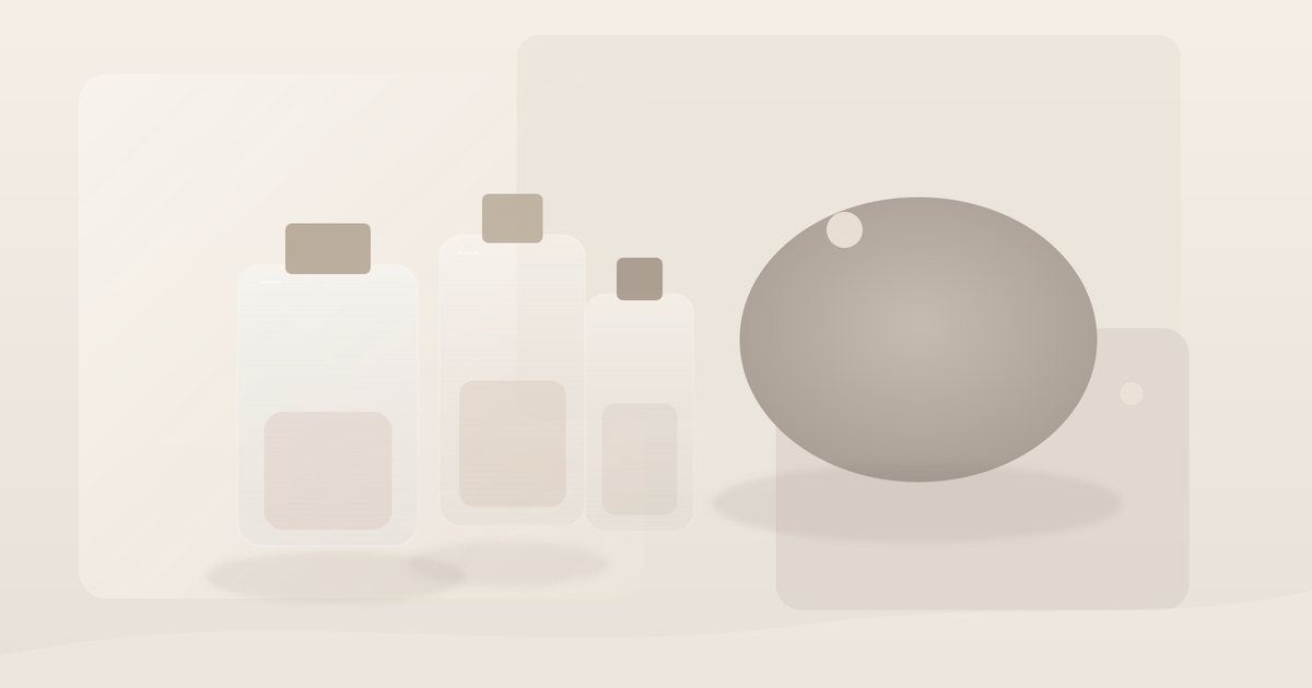 Stone, paper and glass objects arranged in a soft neutral editorial still life with pale fragrance tones
